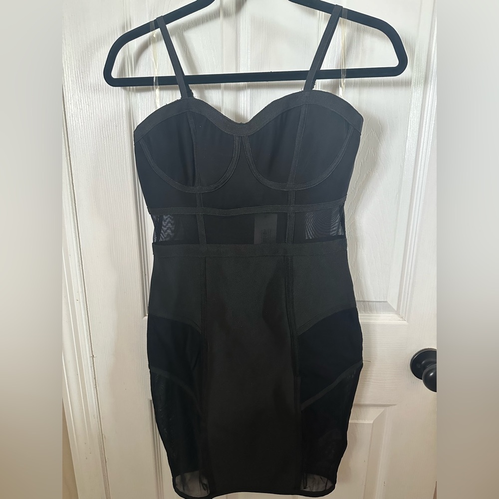 Bodycon black dress with sheer paneling. Size: S
